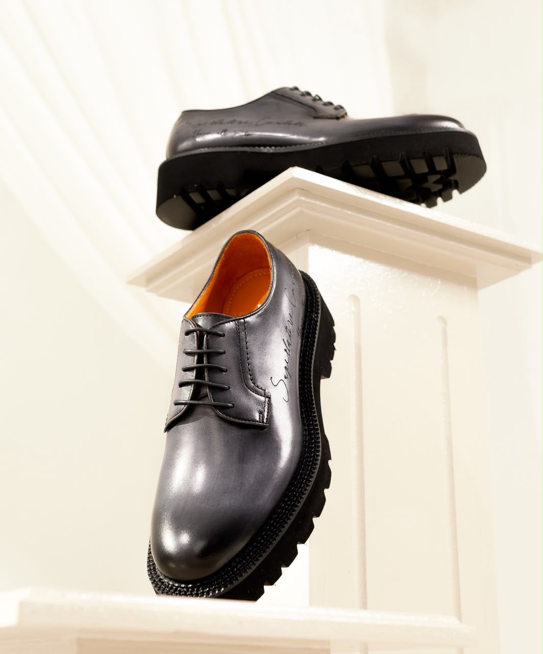 The Noir Oxford, styled on a pedestal display